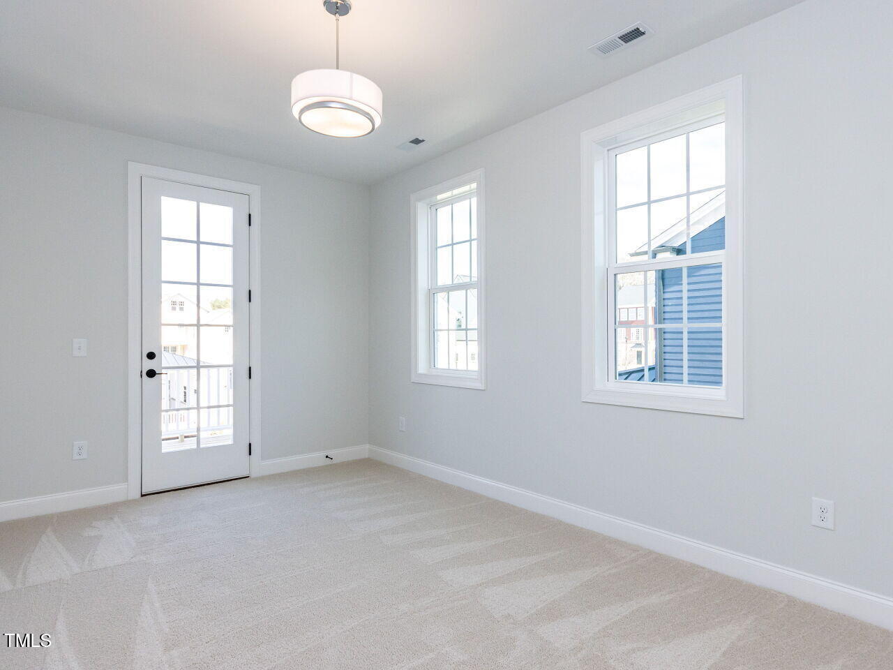 809 St Charles Street Durham, NC 27713 - Photo 32 of 43 an empty room with windows and chandelier fan