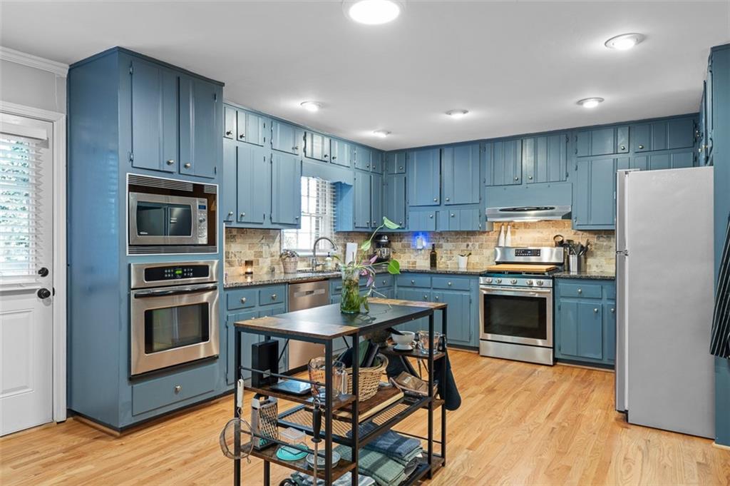 3698 Embry Circle Atlanta, GA 30341 - Photo 11 of 43 a kitchen with granite countertop wooden cabinets and stainless steel appliances