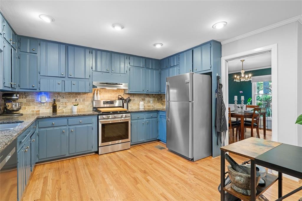3698 Embry Circle Atlanta, GA 30341 - Photo 14 of 43 a kitchen with granite countertop stainless steel appliances a refrigerator and a stove top oven