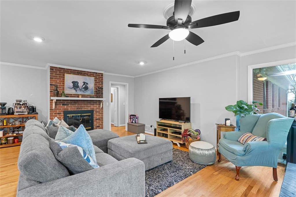 3698 Embry Circle Atlanta, GA 30341 - Photo 16 of 43 a living room with furniture a fireplace and a flat screen tv