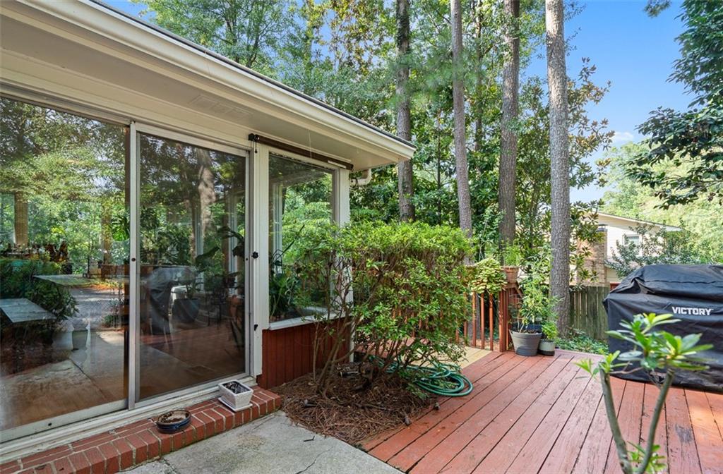 3698 Embry Circle Atlanta, GA 30341 - Photo 36 of 43 a backyard of a house with wooden floor table and chairs