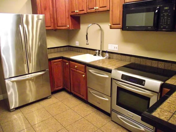 a kitchen with a sink and a refrigerator