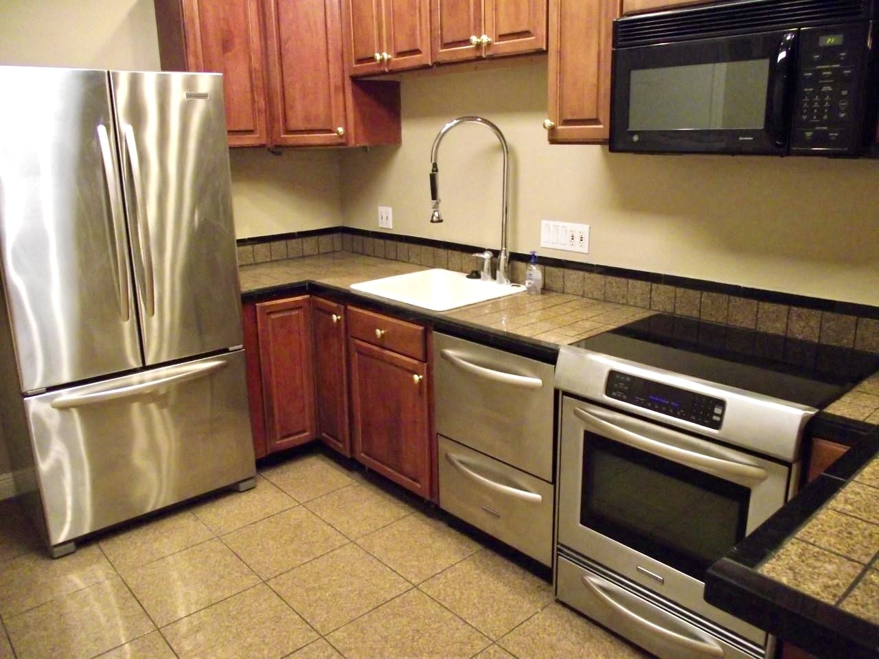 2100 Tanglewilde Street, Unit 537 Houston, TX 77063 - Photo 7 of 13 a kitchen with a sink and a refrigerator