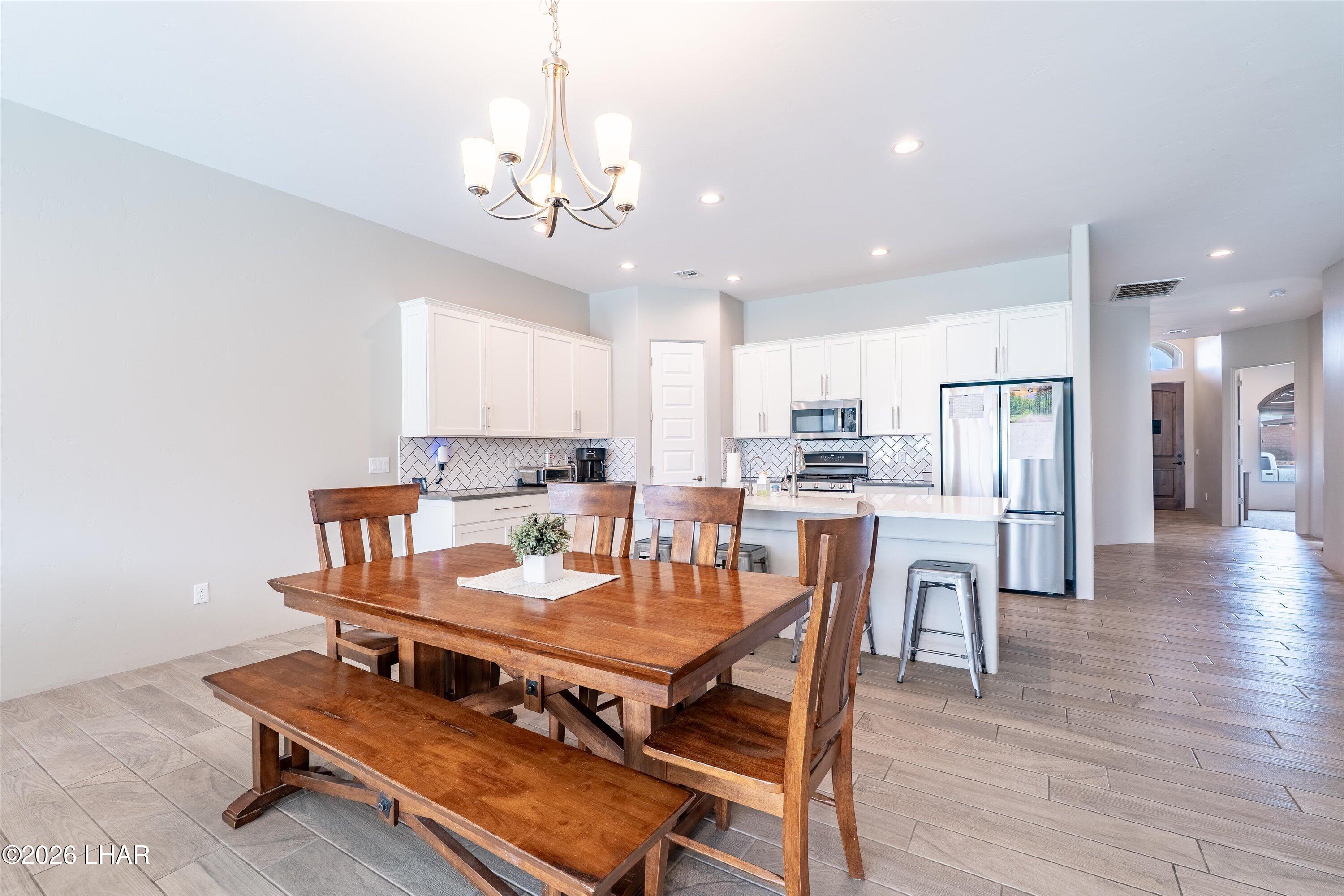 4667 North Juneberry Road Lake Havasu City, AZ 86404 - Photo 12 of 50 a view of a dining room with furniture and wooden floor