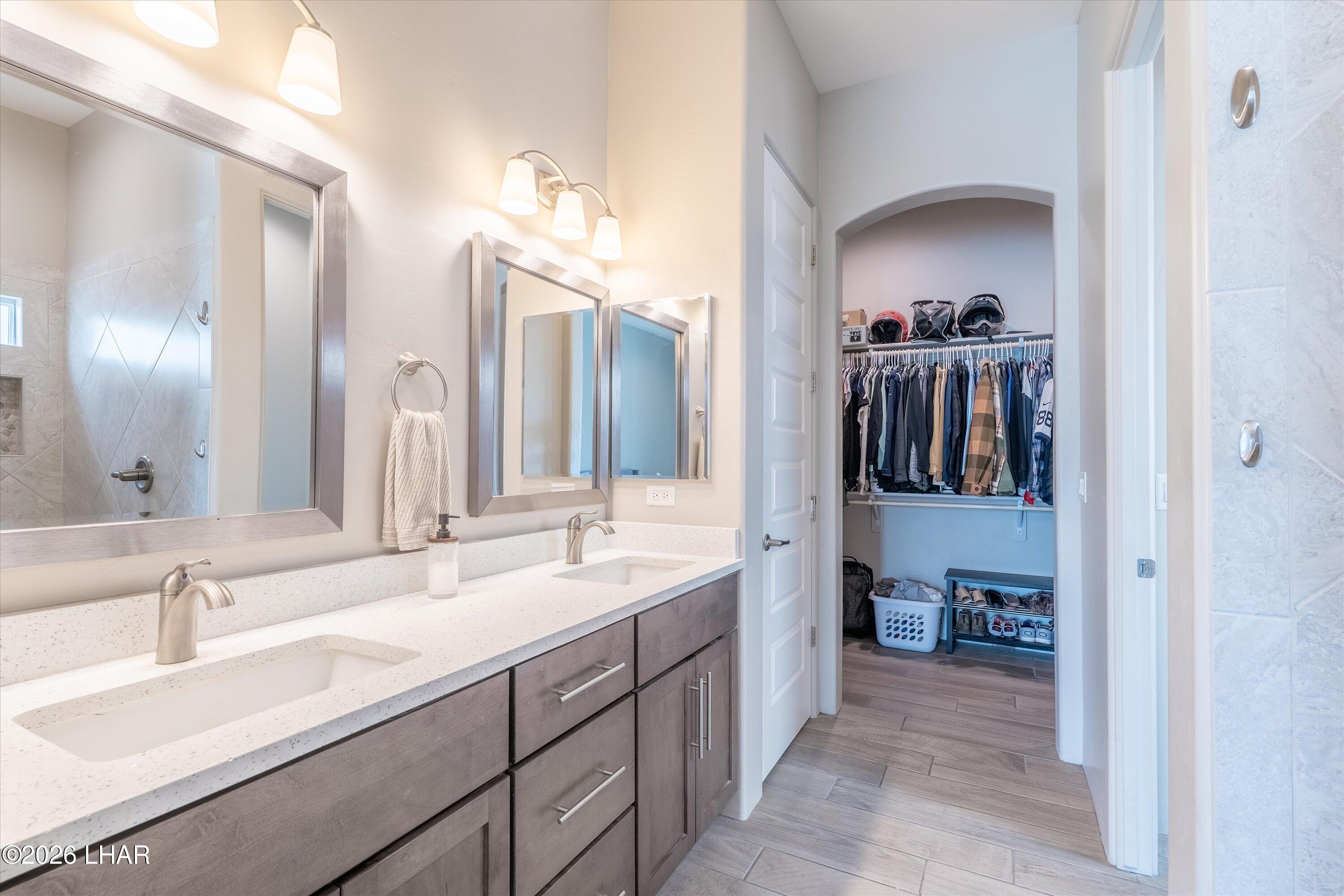 4667 North Juneberry Road Lake Havasu City, AZ 86404 - Photo 15 of 50 a en suite bathroom with a double vanity sink and a mirror