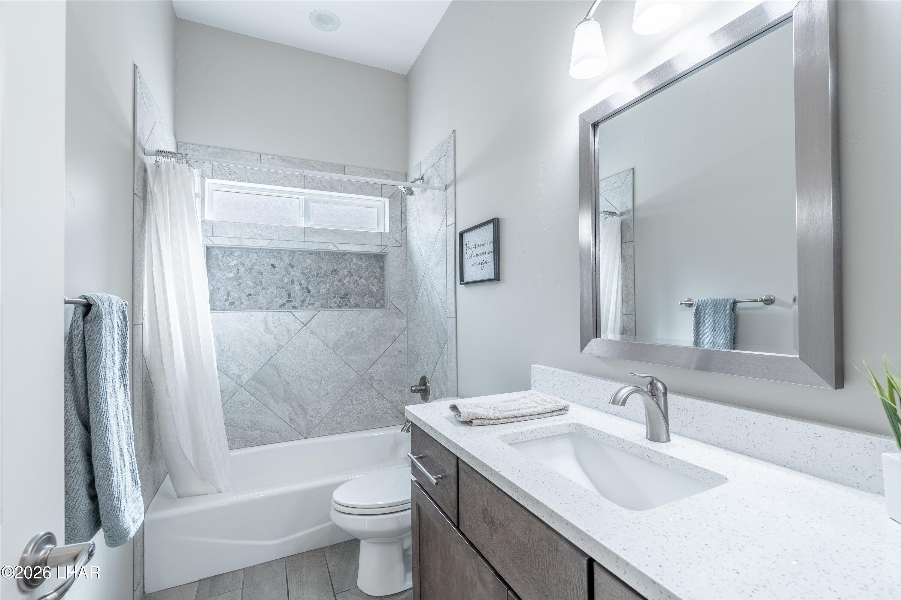 4667 North Juneberry Road Lake Havasu City, AZ 86404 - Photo 19 of 50 a bathroom with a sink toilet and shower