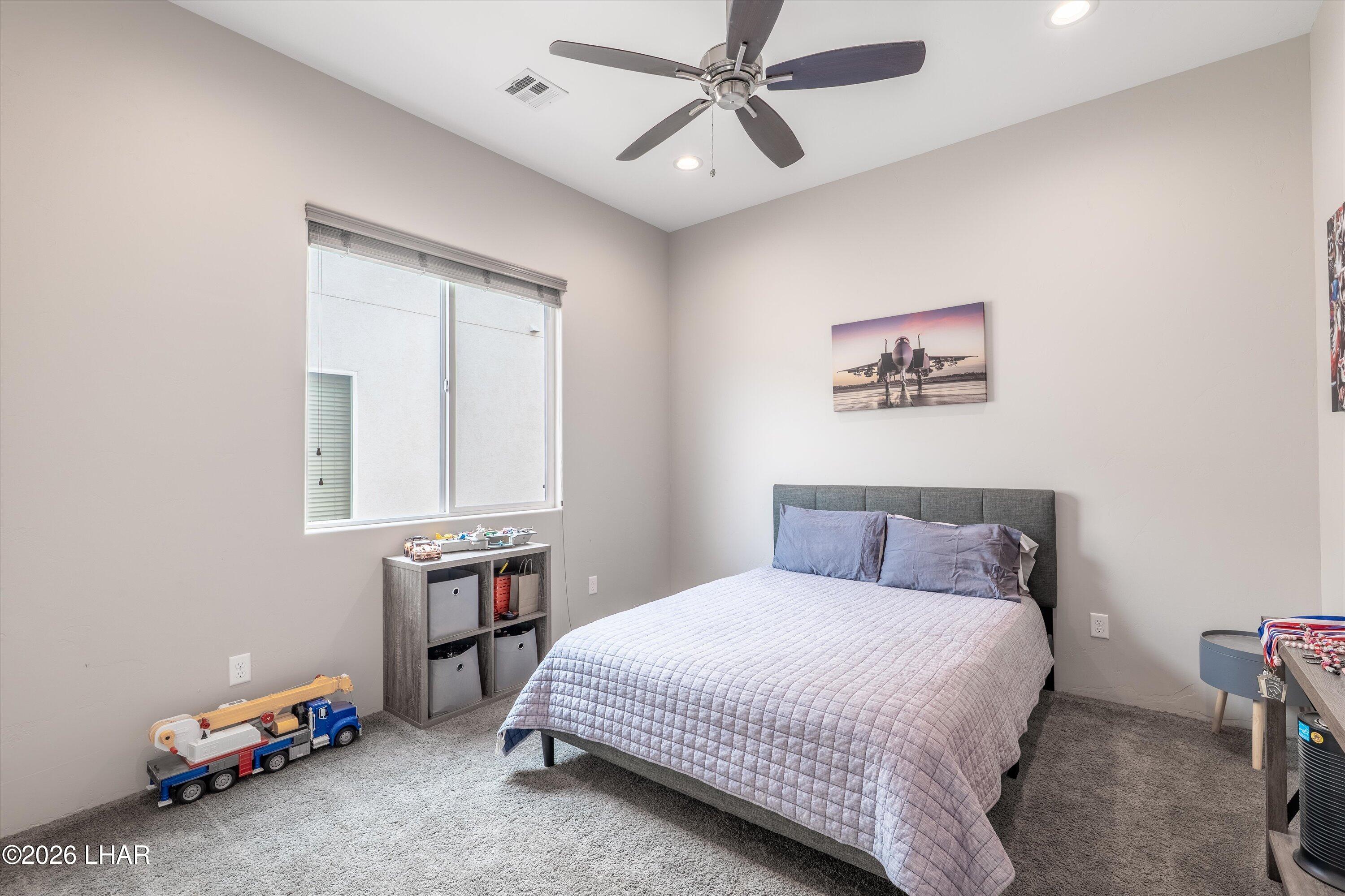 4667 North Juneberry Road Lake Havasu City, AZ 86404 - Photo 21 of 50 a bedroom with a bed a table and chair
