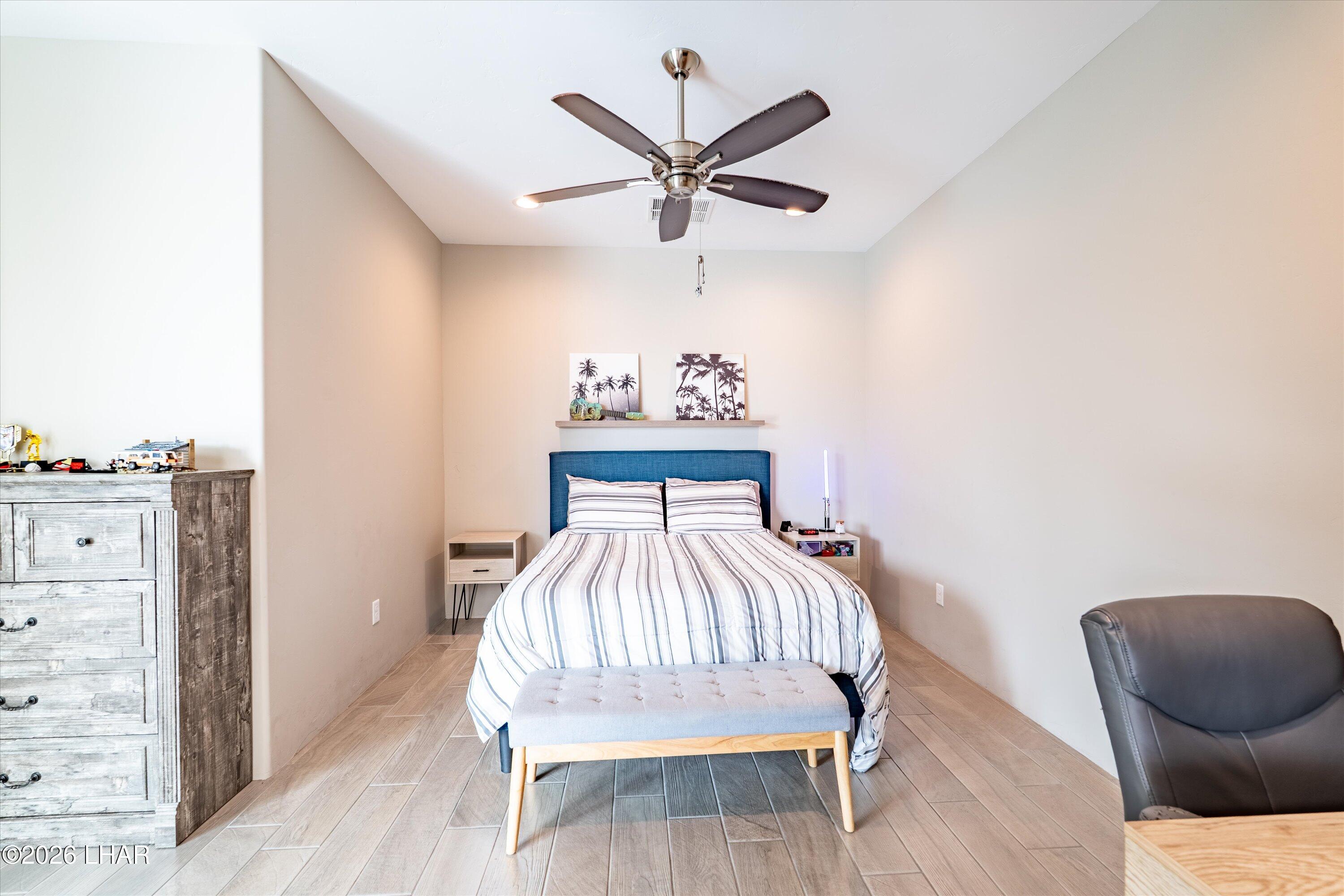 4667 North Juneberry Road Lake Havasu City, AZ 86404 - Photo 23 of 50 a bedroom with a bed and a chair