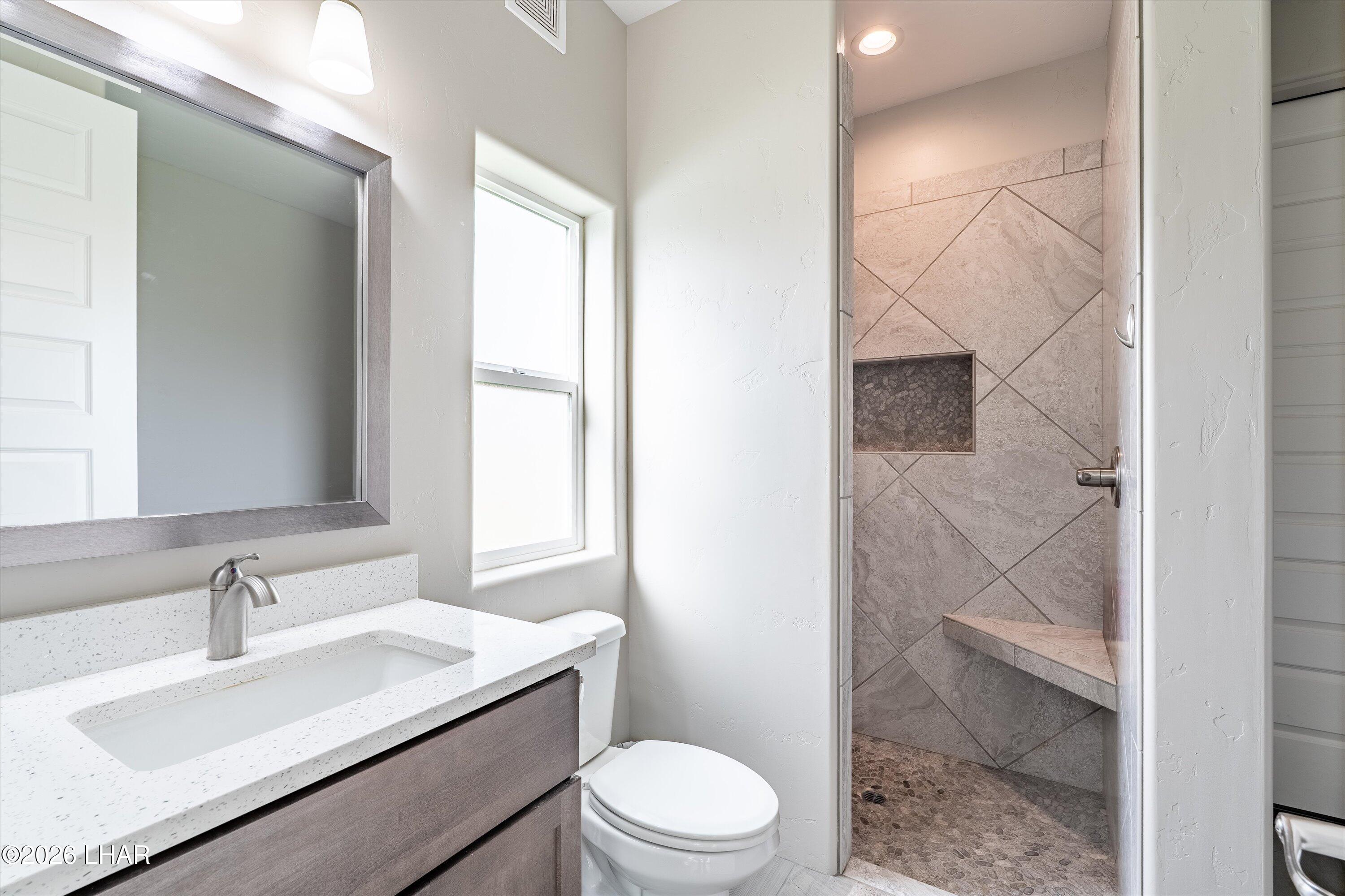 4667 North Juneberry Road Lake Havasu City, AZ 86404 - Photo 24 of 50 a bathroom with a sink toilet vanity and shower