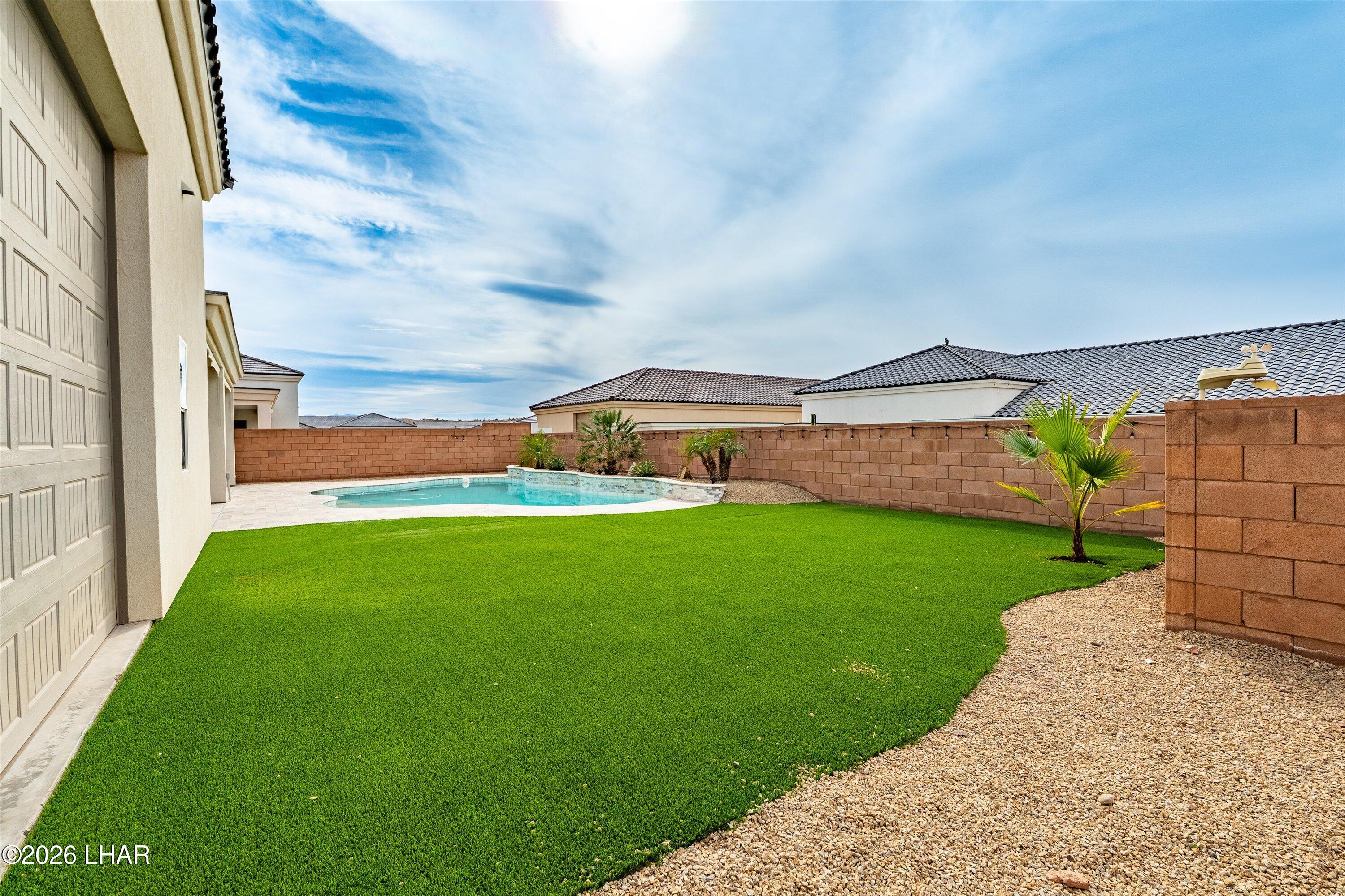 4667 North Juneberry Road Lake Havasu City, AZ 86404 - Photo 30 of 50 a backyard of a house with lots of green space and outdoor seating