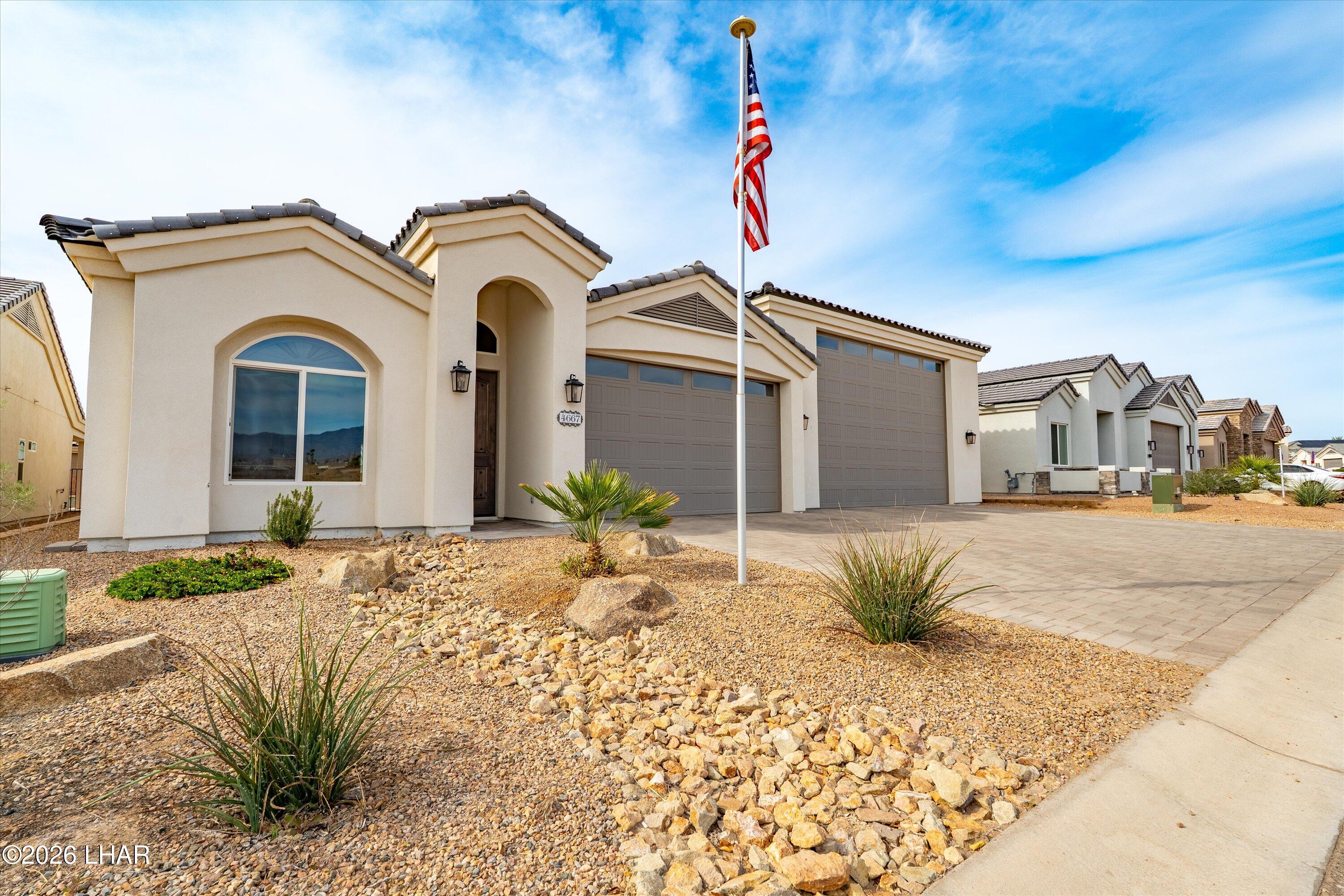 4667 North Juneberry Road Lake Havasu City, AZ 86404 - Photo 3 of 50 a front view of a house with a yard