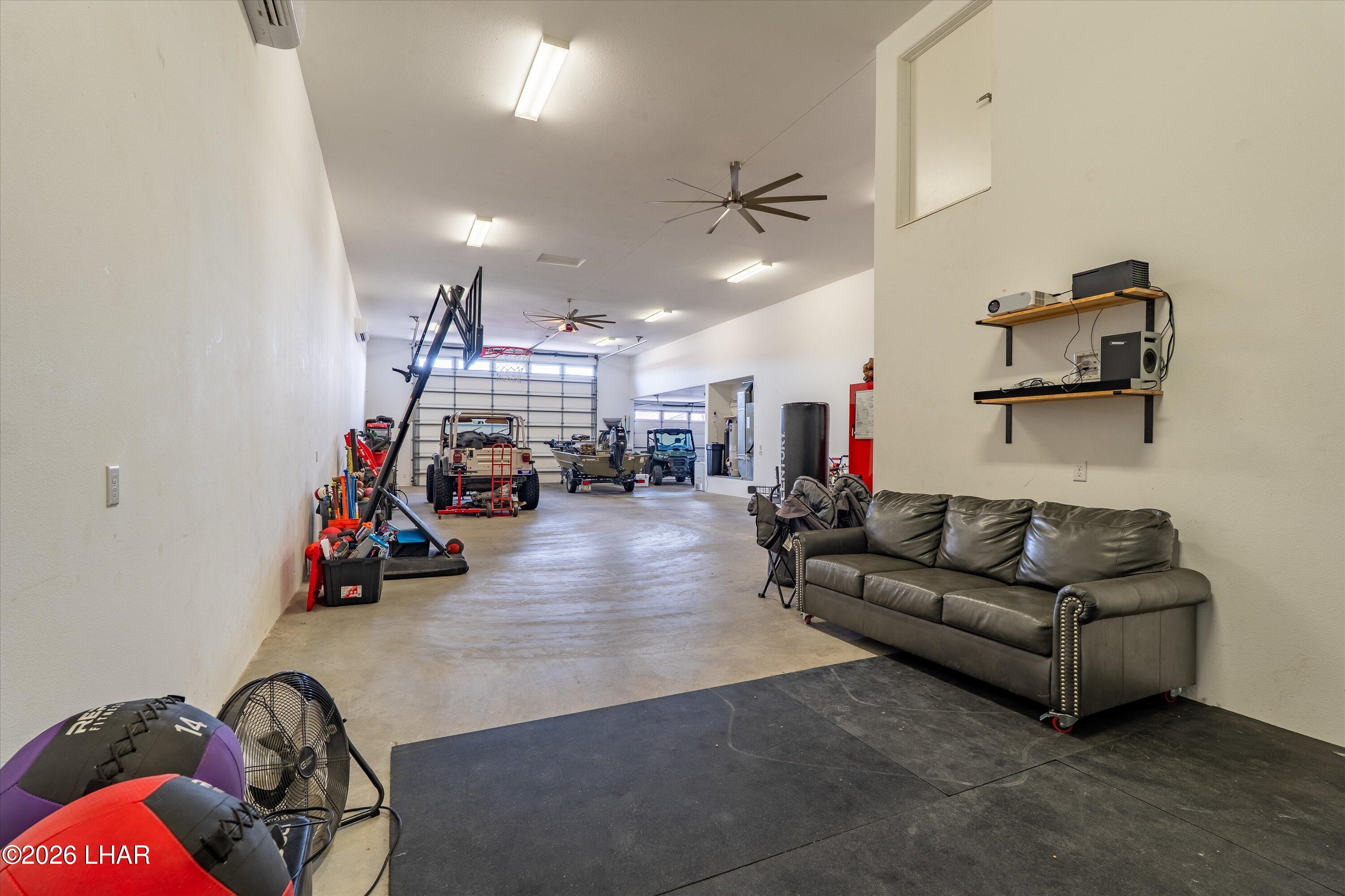 4667 North Juneberry Road Lake Havasu City, AZ 86404 - Photo 37 of 50 a living room with lots of furniture and a gym equipment