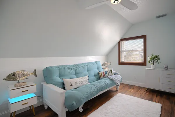 a bedroom with two beds and a flat screen tv