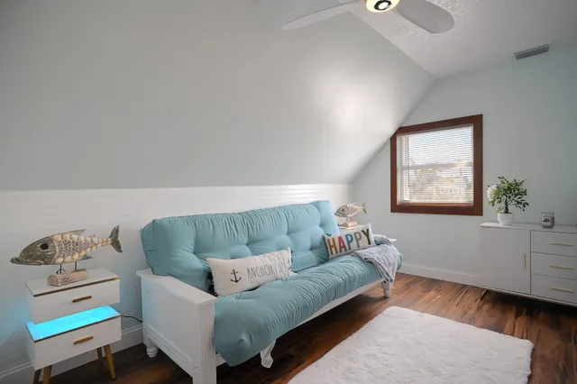 a bedroom with two beds and a flat screen tv