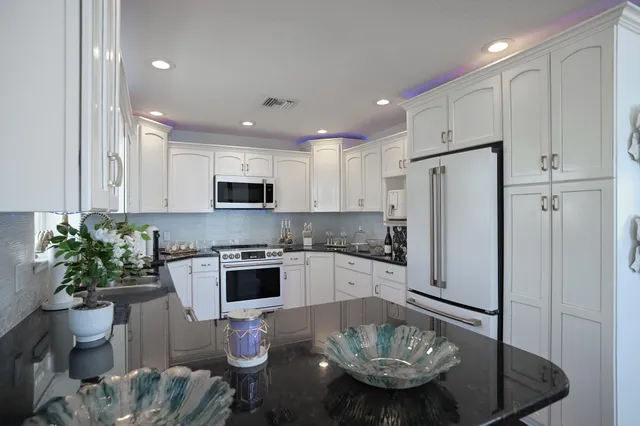 a kitchen with a dining table and chairs