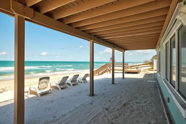 a living room with furniture floor to ceiling window and a flat screen tv