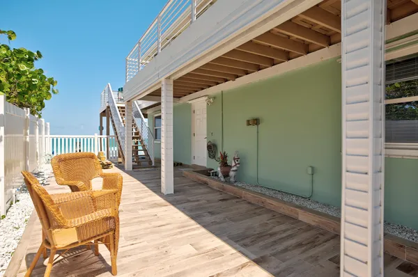 a view of a kitchen with furniture and wooden floor