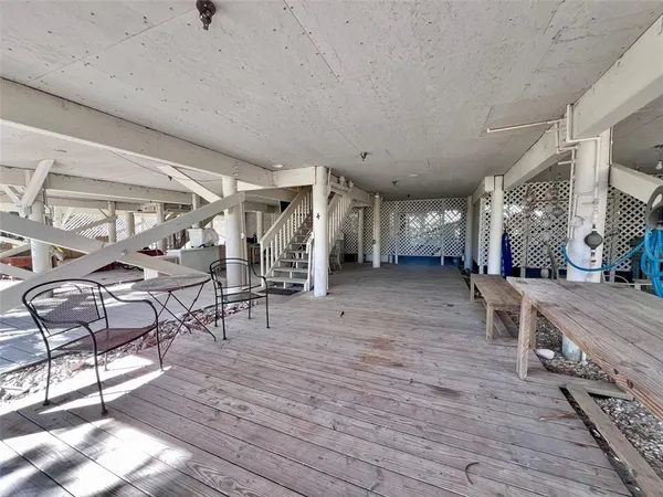 a view of a balcony with wooden floor and city space
