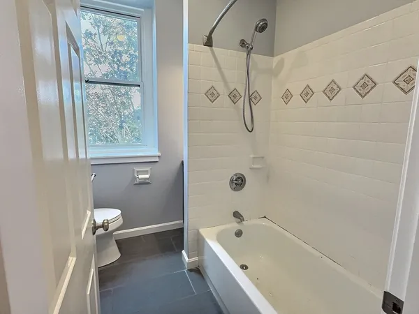 a bathroom with a tub a sink and a shower