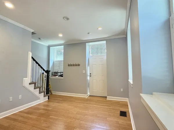 a view of an empty room with stairs and ventilation