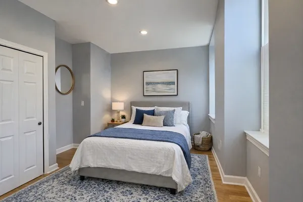 a bedroom with a bed and a window