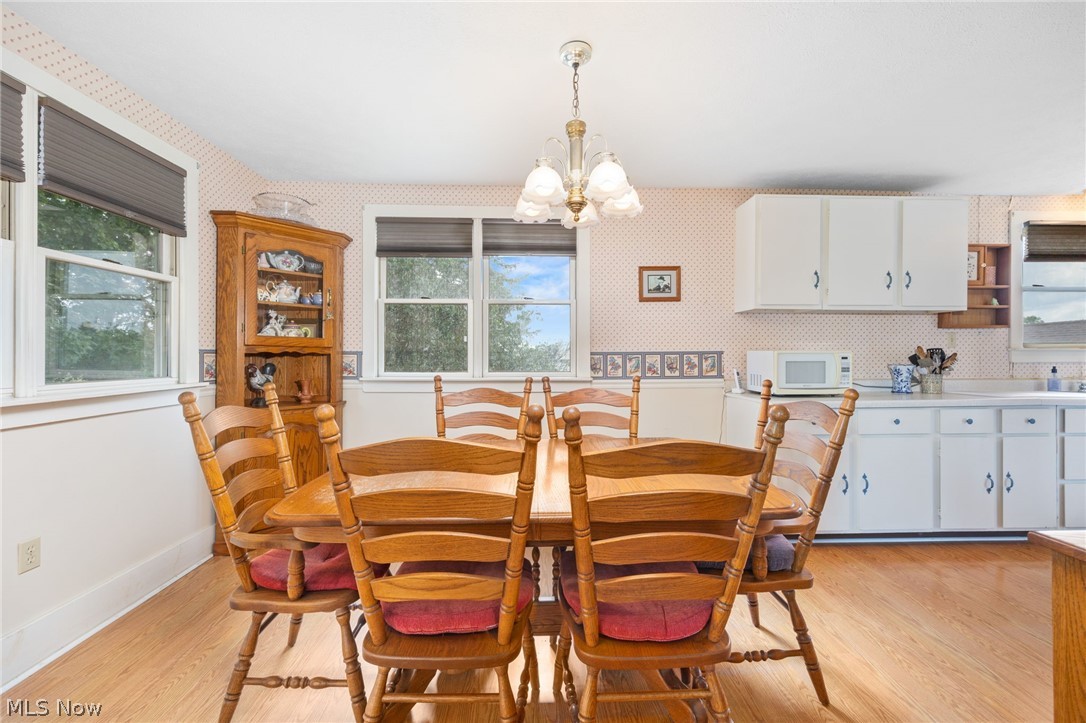 9626 Daniels Road Seville, OH 44273 - Photo 8 of 37 Dining area featuring wood-finish flooring and multiple windows