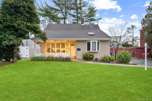 a front view of house with yard and green space