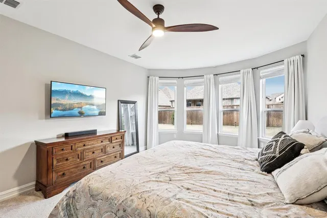 a bedroom with a bed and a flat tv screen