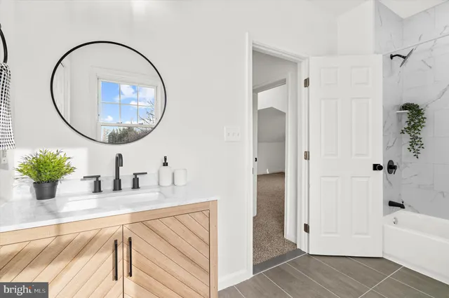 a bathroom with a sink vanity and a mirror