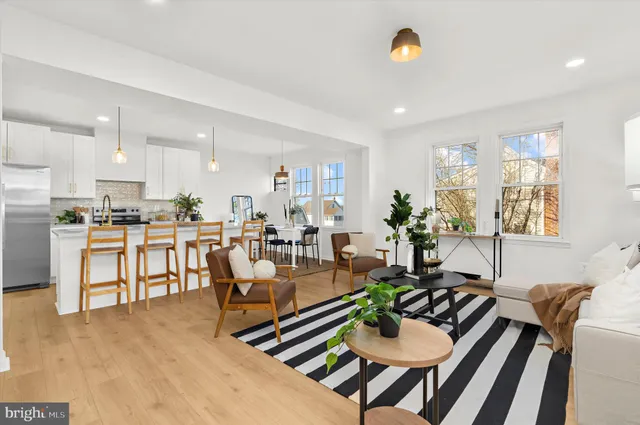 a living room with dining room and kitchen view