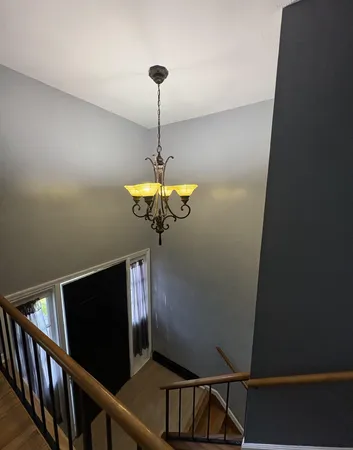 a view of a hallway with a chandelier