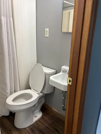 a white toilet sitting next to a bathroom sink