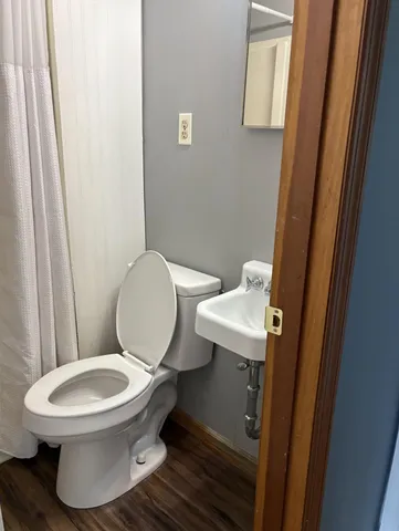 a white toilet sitting next to a bathroom sink