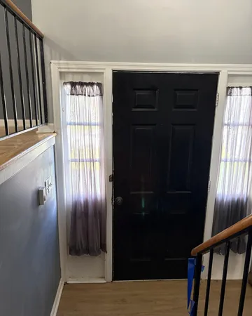 a side view of a house with wooden fence