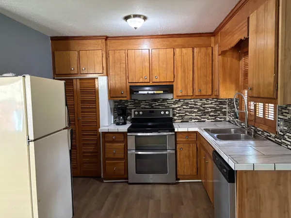 a kitchen with a refrigerator sink and stove