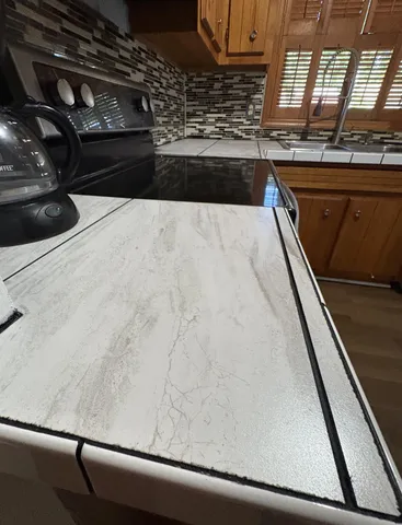 a kitchen with a sink and wooden cabinets