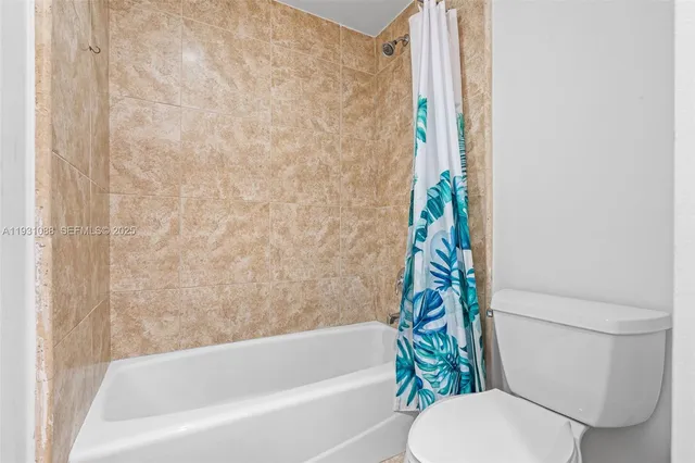 a bathroom with a sink a toilet and a large mirror