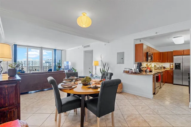 a dining room with furniture and a floor to ceiling window