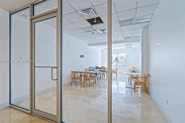 a dining room with furniture and a chandelier