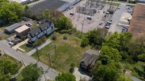 an aerial view of multiple houses with yard