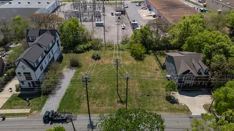 an aerial view of a residential apartment building with a yard