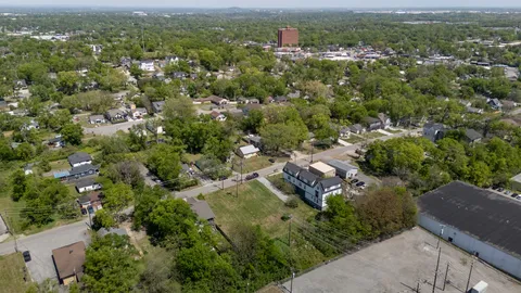 an aerial view of residential houses with city view
