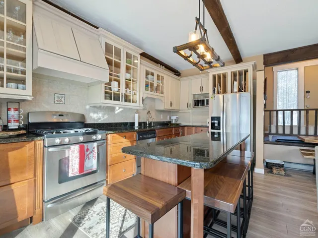 a kitchen with stainless steel appliances granite countertop a stove and refrigerator