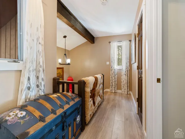 a bedroom with a large bed and a chandelier fan