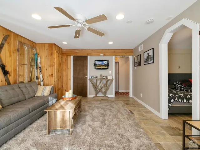 a living room with furniture ceiling fan and a rug