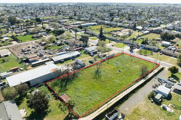 an aerial view of residential houses with outdoor space and swimming pool