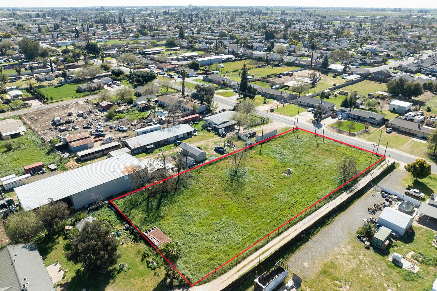16834 Letteau Avenue Delhi, CA 95315 - Photo 7 of 9 an aerial view of residential houses with outdoor space and swimming pool
