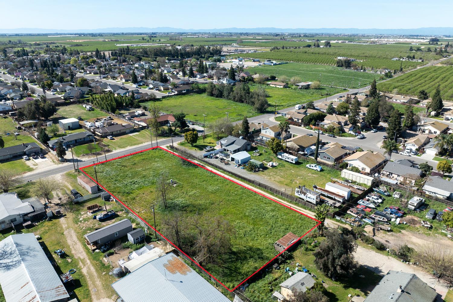 16834 Letteau Avenue Delhi, CA 95315 - Photo 9 of 9 an aerial view of a city with lots of residential buildings and mountain view in back