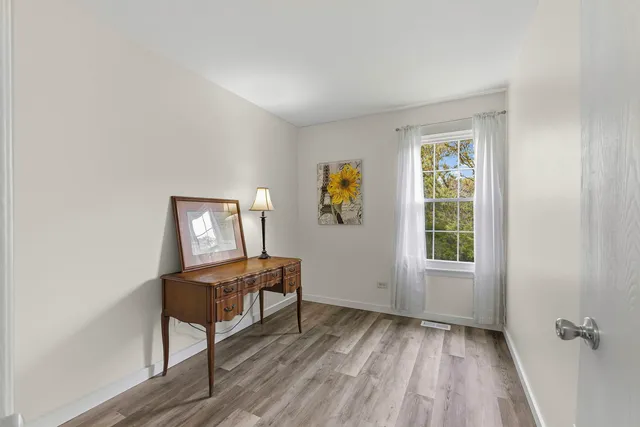 an empty room with windows and closet