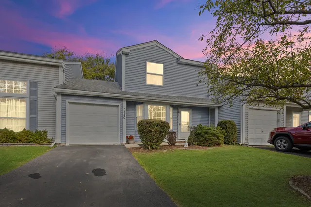 a front view of a house with a garden and plants